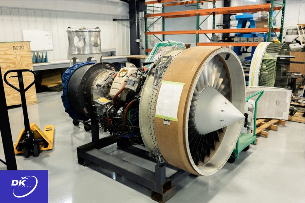 Aircraft engine in a testing facility with exposed components, illustrating materials testing processes for aviation part durability and safety compliance.
