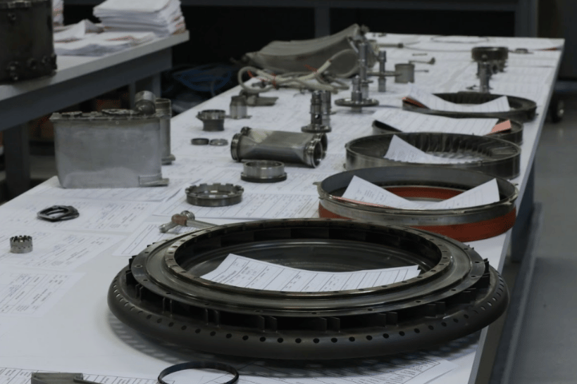 DK Turbines aircraft parts laid out on table with paperwork