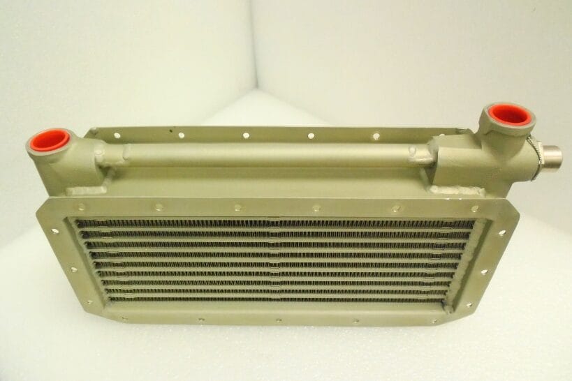 Detailed close-up of an aircraft oil cooler manufactured by DK Turbines